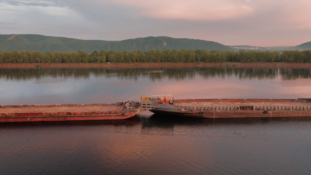 Tugboat pushing the barge ship
