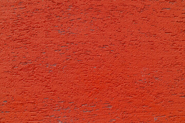 Red plaster wall of a building. Rough surface texture.