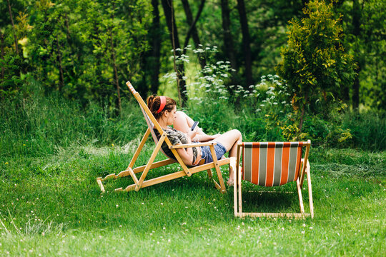 Woman sit in comfortable folding chair in nature