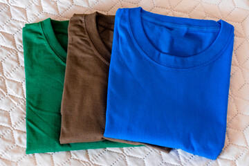 Folded t-shirts different colours. Sportswear in the store