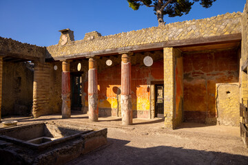 Casa della Gemma in Ercolano with columns. Ruins of ancient roman town Ercolano - Herculaneum, destroyed by the eruption of the Mount Vesuvius, Vesuvio volcano. Historical park of Ercolano, Italy