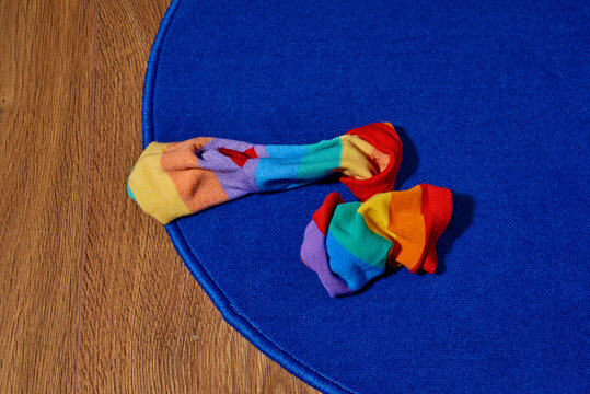 rainbow patterned socks trhown on the floor