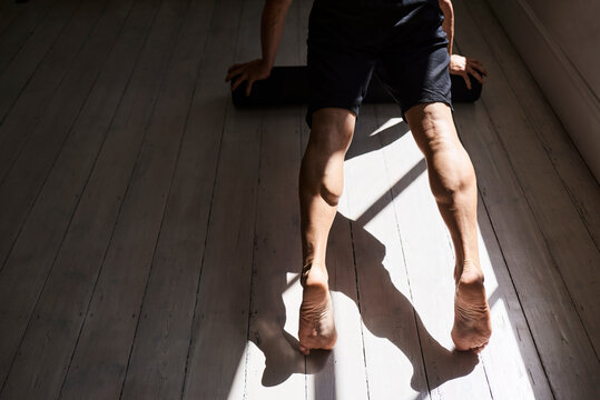 Crop sportsman doing push ups during workout