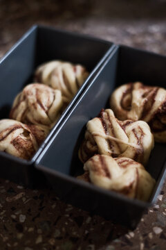 Uncooked buns in baking pans