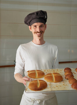 Portrait of a professional baker with bread buns