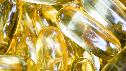 Astonishing closeup of Omega 3 capsules (pills), stacked together in a pile. Medical journals and...