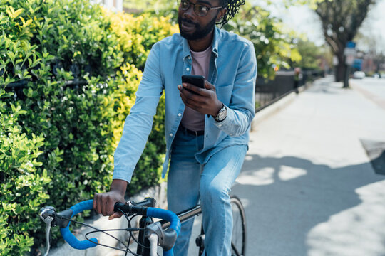 Cyclist holding a mobile Phone