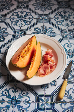 Melon + Prosciutto on a Tiled Table