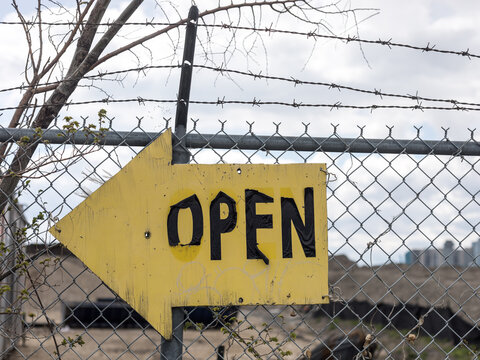 'Open' sign on a fence