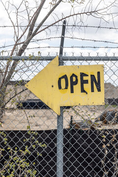'Open' sign on a fence