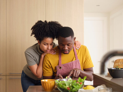 Content Black Couple Making Healthy Salad At Home