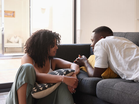 Black couple at couch in living room