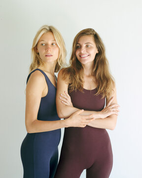 Two young women posing in yoga clothes