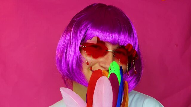 Girl with bright hair color rejoices in life - Pink background.