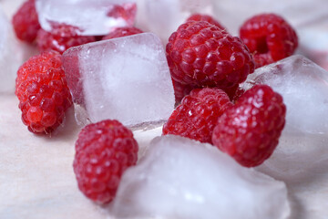 Fresh raspberries in ice, close-up