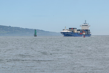 Cargo ship entering Dublin harbour at Poolbeg lighthouse.