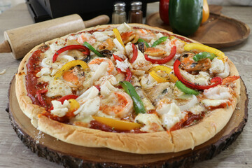 Homemade pizza topped with seafood, bell pepper, delicious.