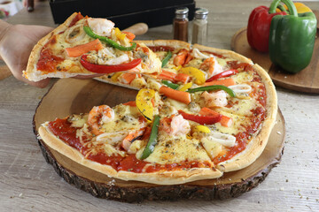 Homemade pizza topped with seafood, bell pepper, delicious.