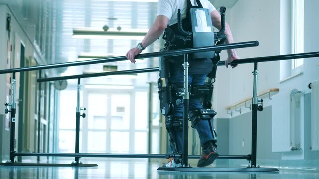 Disabled Man Is Learning To Walk In The Exoskeleton