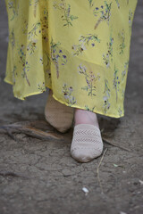 Stylish woman wearing summer shoes with straw sole outdoors. 