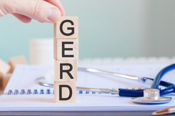 wooden block form the word gerd with stethoscope on the doctor's desktop, medical concept