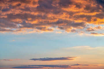 orange sunset sky with lighted clouds
