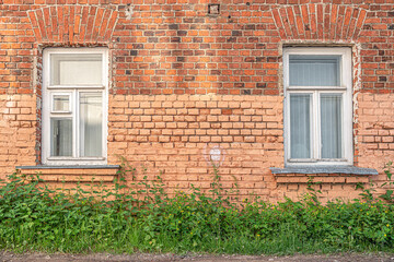 Fototapeta na wymiar windows with wooden frames in an old red brick house
