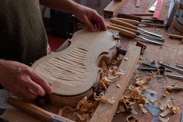 Luthier workshop where violins are building with different tools to work on wood - obrazy, fototapety, plakaty