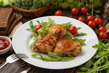 Baked chicken legs on wood background