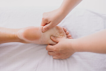 Foot massage close-up. Spa salon self-care relax. Kneading the feet. Pleasant pleasures. The masseur is working. Treating fatigue and leg pain. Health care acupuncture. massaging Heel fingers foot