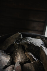 Hot stones in the sauna close-up. Heater heat generator. beautiful luxury equipment. Black stone...