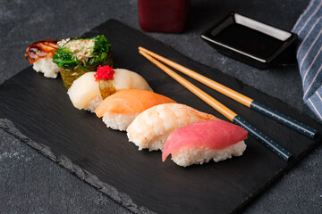 Sushi on a black slate plate