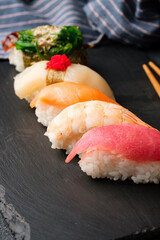 Sushi on a black slate plate