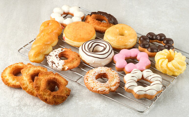 Many different donuts on a light background.