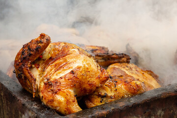 1/2 a Jerk Chicken on open fire with smoke background