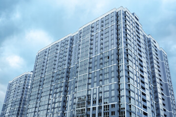 Fototapeta premium Multistory house. New apartment facade in big building modern flat apartment complex. New house condominium building real estate modern residential architecture. Condo building residential property