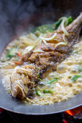 Steamed Snapper Fish Served in Pot with Crackers. Pot Boiling