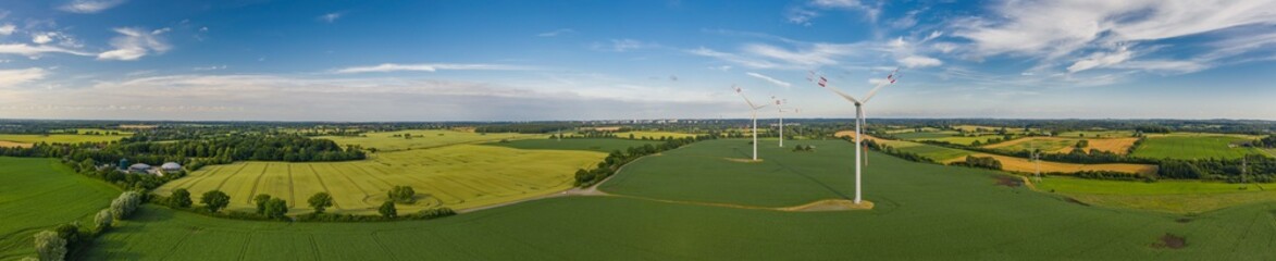 Panorama aerial view of countryside infrastructure windmills, agriculture fields, plant and farm....