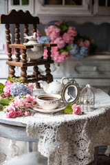 Still-Life with purple and pink Hortensia flowers, breakfast table setting.