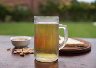 cup of beer and pizza slice leaning on a table
