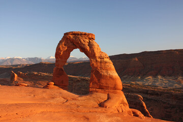 delicate arch and the la sal mountains in late afternoon, in arches national park, near moab,  utah
