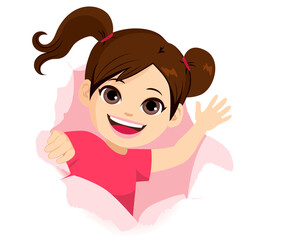 Cute happy little girl smiling and waving hand breaking through ripped paper hole