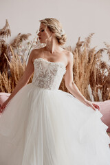Fototapeta na wymiar Bride in white dress, lace bodice. A look aside.