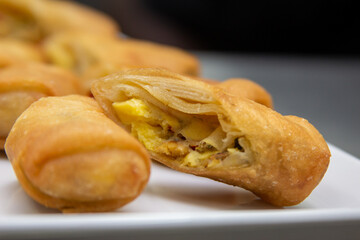 Ackee & Saltfish Spring Roll On White Plate With Black Background