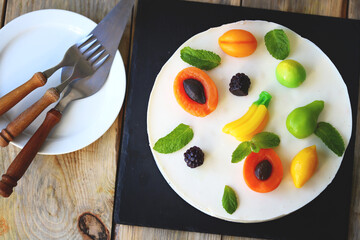 White soufflé cake with marmalade fruits.