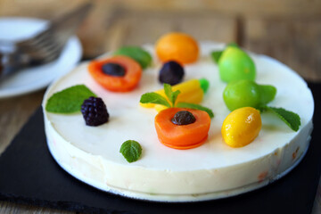 White soufflé cake with marmalade fruits.