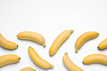 Sweet ripe baby bananas on white background, top view