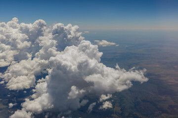 Overview of fluffy clouds in mountains from an airplane, Arizona