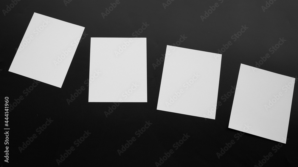 Wall mural Blank Mock-up paper. brochure magazine isolated on black table, changeable background , white paper isolated on dark tone.