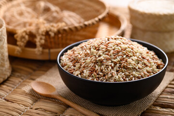 Organic Thai highland brown rice grain in a bowl (Cargo rice, Loonzain rice or Husked rice), Healthy food